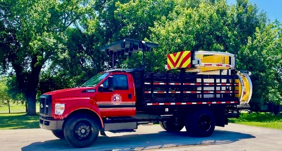Red fire department truck with highway blocker apparatus